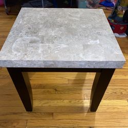 2 Granite end tables and a plant.