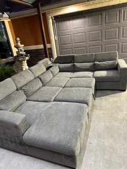 Beautiful large grey sectional with storages and pull out bed super comfy and nice asking 680