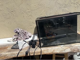 20 gallon saltwater aquarium setup. Includes tank, live rock, heater, wavemaker/pump, ceramic filter media, and lid. Selling everything together.”