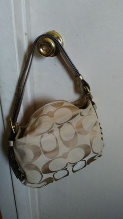 Medium Coach purse tan and light brown with gold hardware.