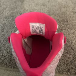 Pink and white Jordan 12s