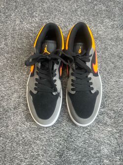 Nike Air Jordan 1 Low SE in the "Light Graphite / Vivid Orange" colorway.