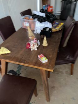 Wooden and leather dining room set from Ashley’s furniture home store