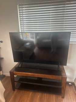 Tv Stand. Glass panels wood and metal frame.