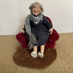 Vintage porcelain grandma doll in armchair