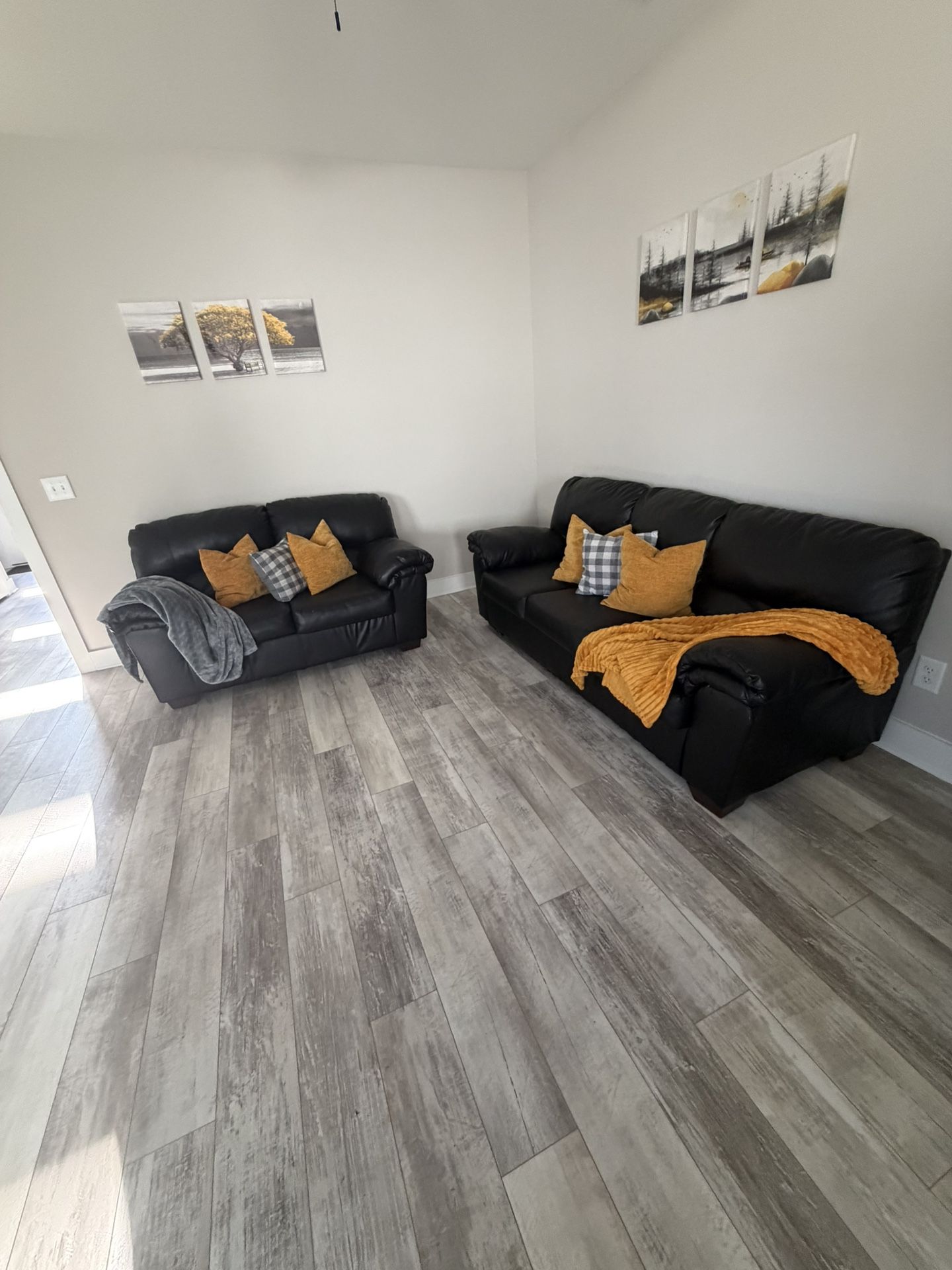 Sofa And Love Seat With pillows And Pictures