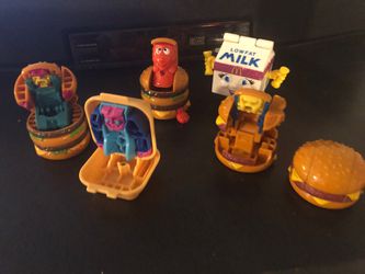 Bin of vintage Mcdonald’s happy meal toys including the original hamburger double cheeseburger and French fries transformers