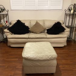 Leather Sofa With Matching Ottoman And Decorative Metal Shelving Units 