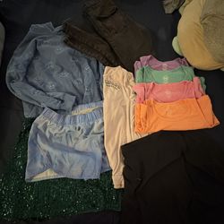 14-16 girls 4 tanks 2 skirts a pair of shorts, hoodie , long sleeve shirt and pants (used)