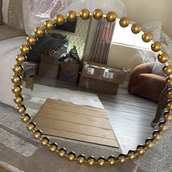 Gold round mirror