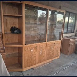 wooden display cabinet with glass doors and shelves.