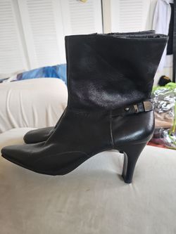 Bandolino black leather ankle boots with a decorative side buckle and a pointed toe.
