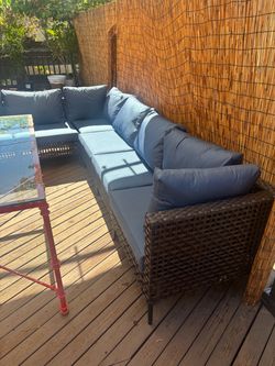 Boho Modern Rattan Modular Patio Sofa set conversation pit with navy blue cushions and coffee table