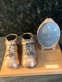 Copper covered baby shoes frame with curved glass vintage