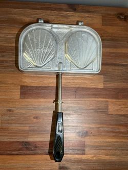 This is a vintage Sefama sandwich maker or panini press, made in France and featuring a seashell design.