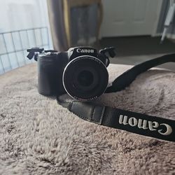 black Canon PowerShot SX510 HS digital camera featuring a 30x optical zoom lens.