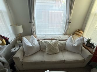 Beige Couch and Ottoman Accompaniment