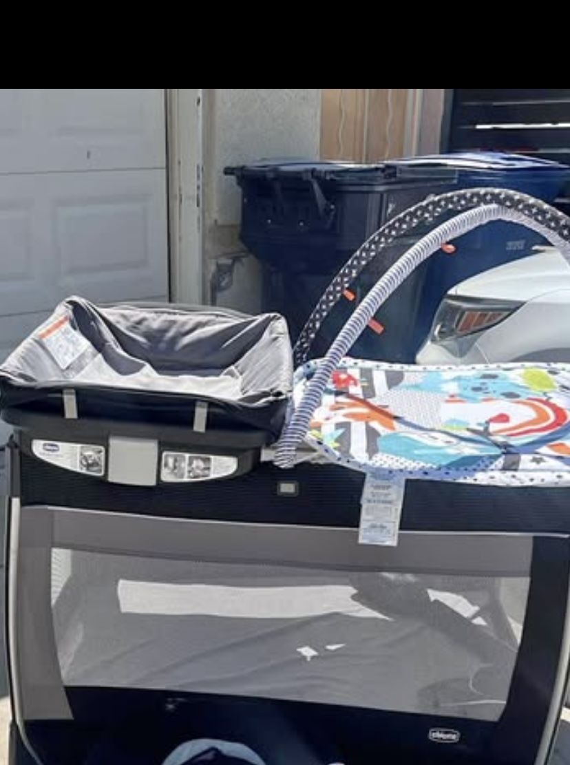 Gently used play pin with diaper changing table/diaper storage