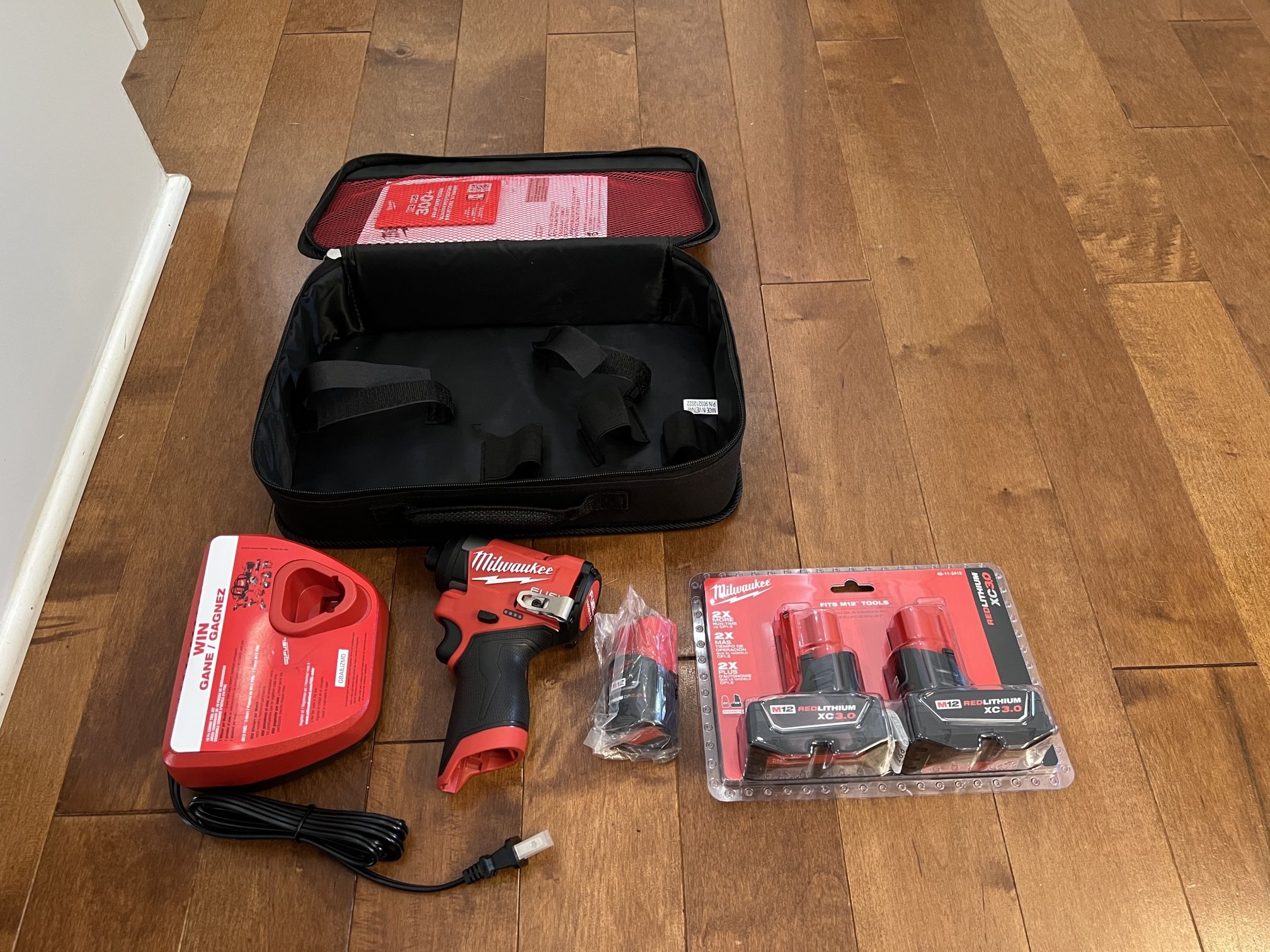 Brand New Milwaukee M12 Impact Driver 3453 Plus Batteries, Charger, And Bag