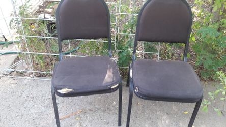 Two black stacking chairs for $20.