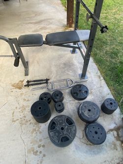 Weight bench with barbell and weights