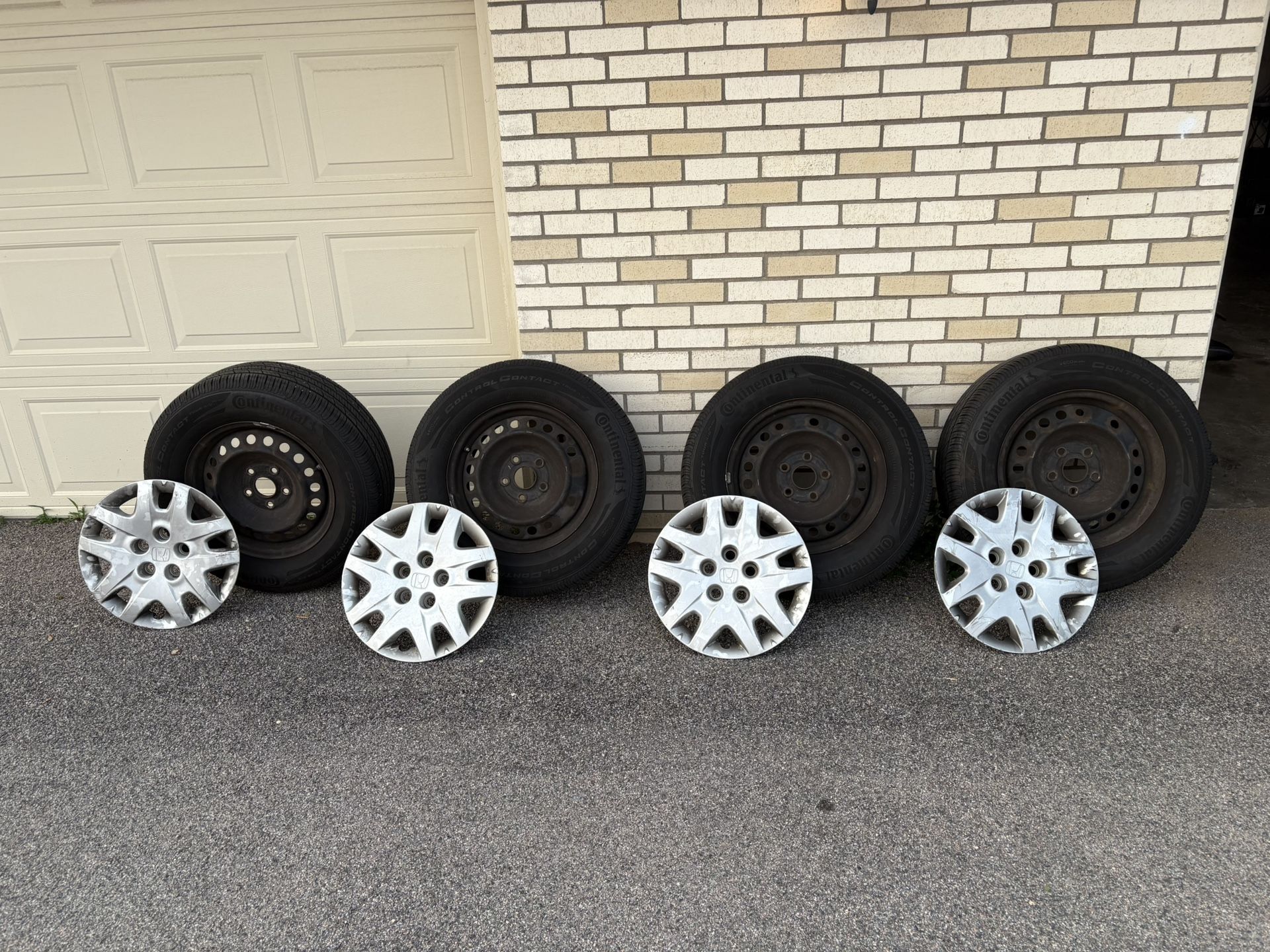 4 Honda tires with rims and covers size 235/65 R 16