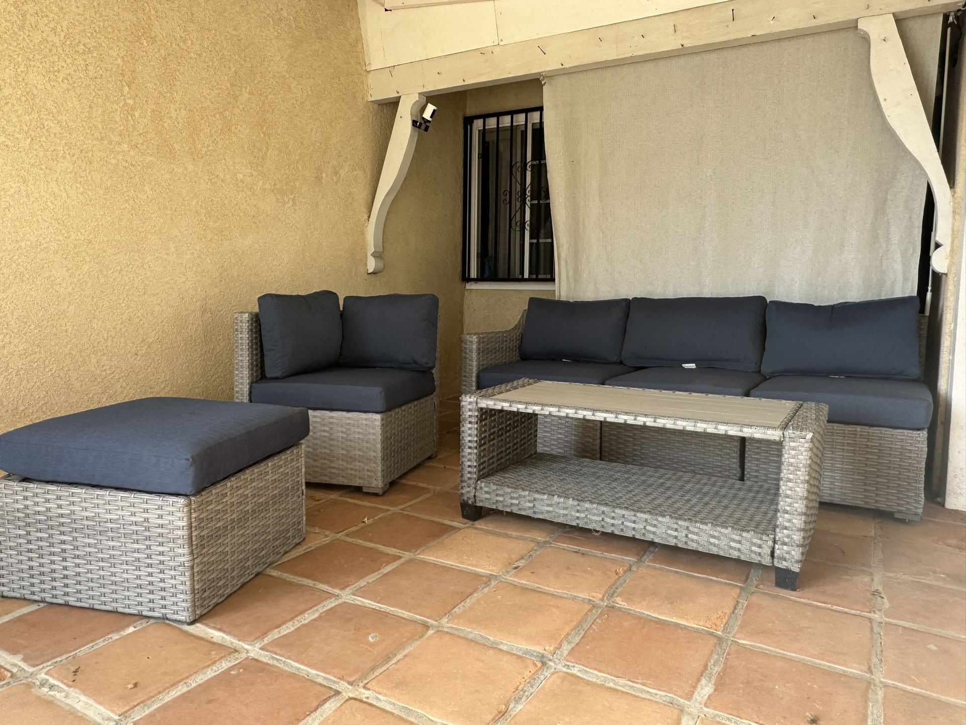 Wicker Outdoor Sectional with Blue Cushions and Iron Frame