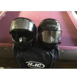 Two snowmobiling helmets