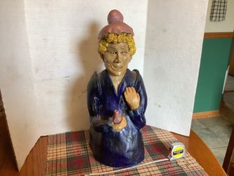 Vintage 1940s piece painted blonde ceramic figure approximately 14” tall great bold colors, very heavy. She appear to be holding a bottle. Plainfield,