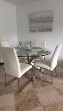 Glass chrome table with white leather chairs