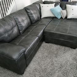 Beautifu Grayl Sectional Leather Couch Ottoman Great Condition Like New Less Than Year.  Has No Dent, No Scratches .... Delivery Available For Fee