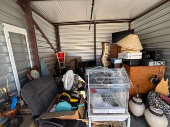 Auction Unit 501 6/26 - Safe, clocks, chair, computer, decorations, lamp,  fans, Animal-traps