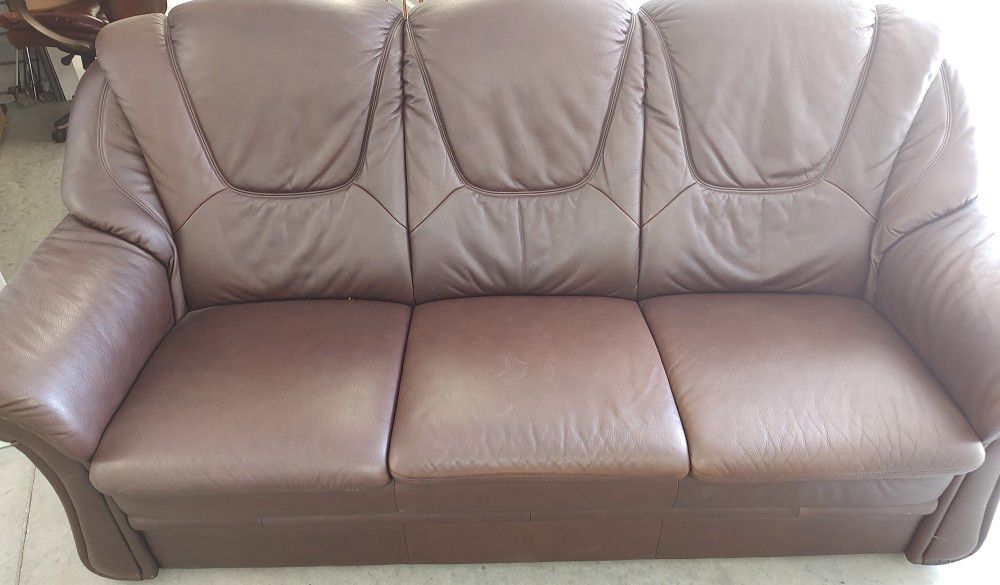 Beautiful brown bonded leather three cushion couch.