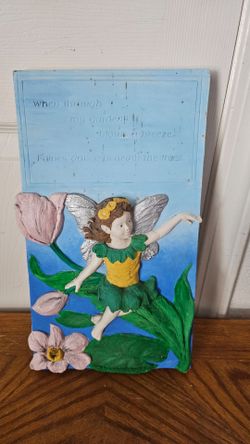 CERAMIC WALL PLAQUE WITH FAIRY ON IT