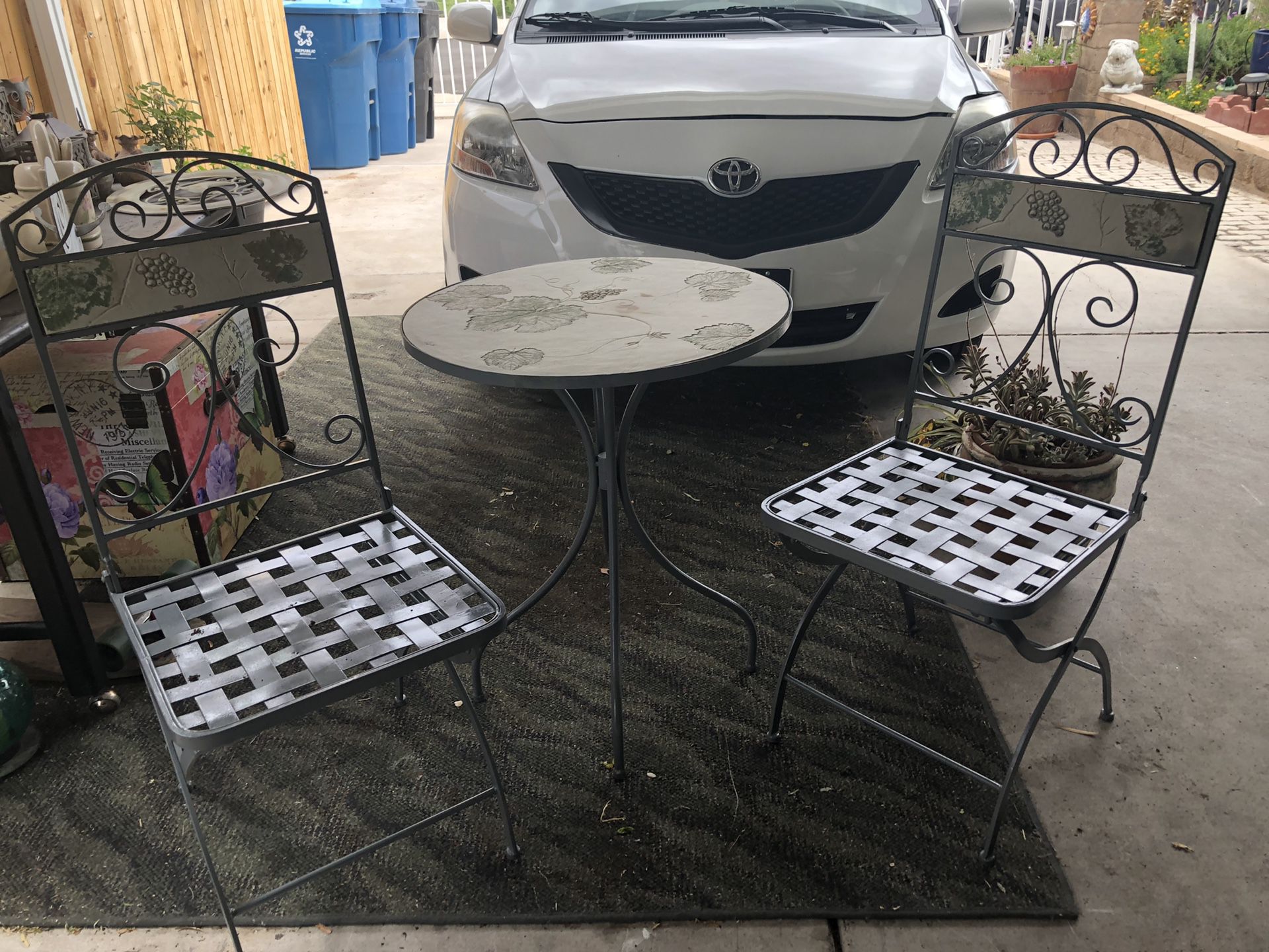 Garden table and 2 chairs ( chairs are cast iron and they fold)