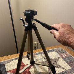 Camera tripod with crank height adjust.