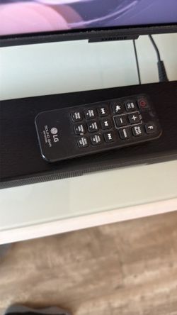 LG soundbar with subwoofer and remote.