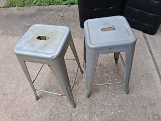 2 gray metal bar stools