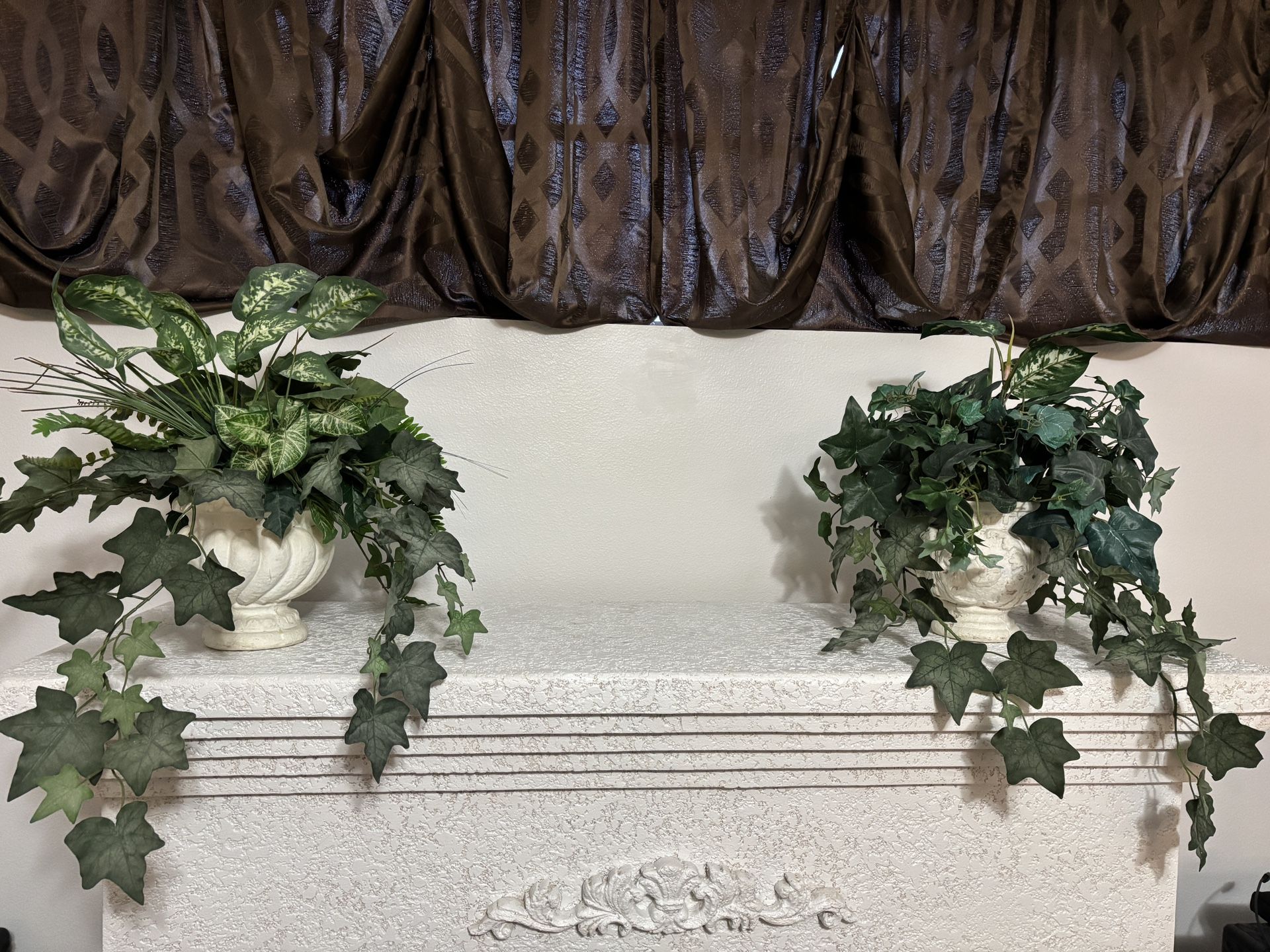 Pair of artificial vine plants in faux stone planters