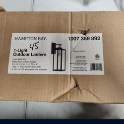 Hampton bay Maplebrook Outdoor Wall sconce light fixture in black with gold accented light bulb base