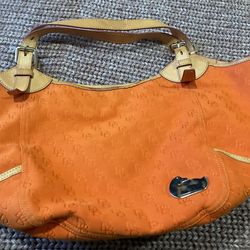 Dooney &Bourke  orange  purse  inside  is the slightest  bit  of dirty