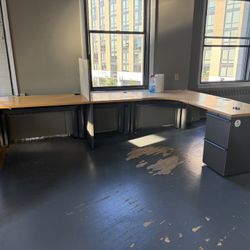 Large office desk with attached drawers.