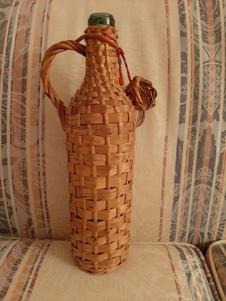 Vintage Greek wine bottle with wicker case.