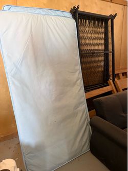 Four twin size beds with mattresses.