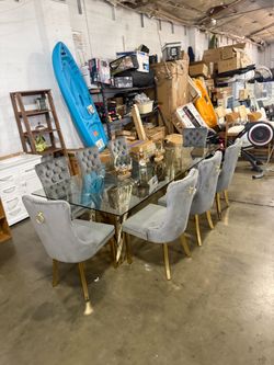 New dining set with 8 chairs; the table is metal and glass.
