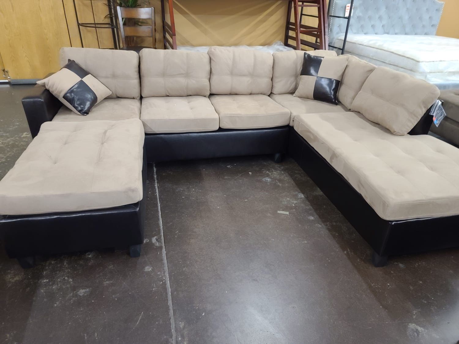 Two tone tan microfiber sectional with a matching ottoman