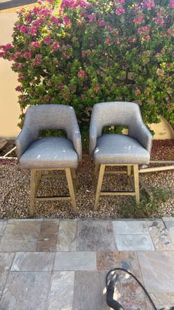 Two blue woven counter stools