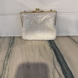 This is a vintage Magid white hand-beaded evening clutch