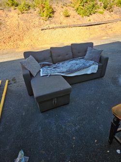 Couch with pullout part and storage space. Does have few stains. Make offer