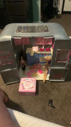 Barbie Dreamhouse with some dolls and clothes and kitchenware